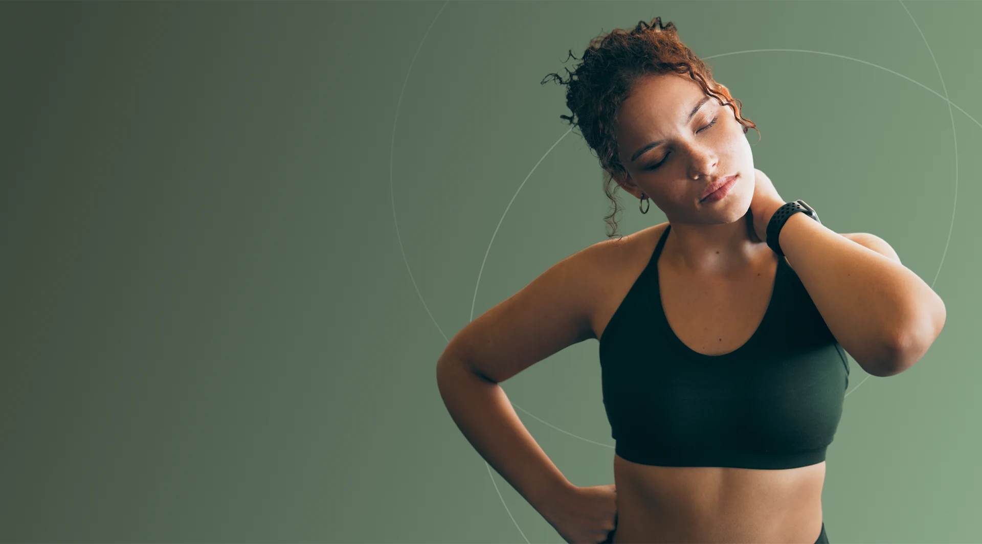 Woman in a sports top stretching, one hand on her shoulder