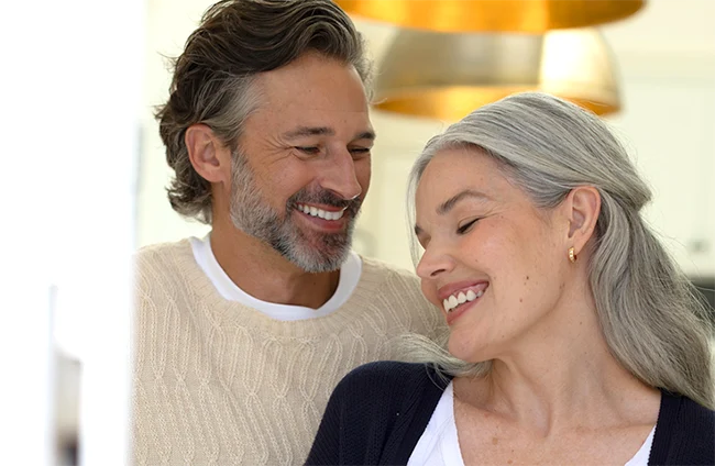 Smiling man and woman leaning close together